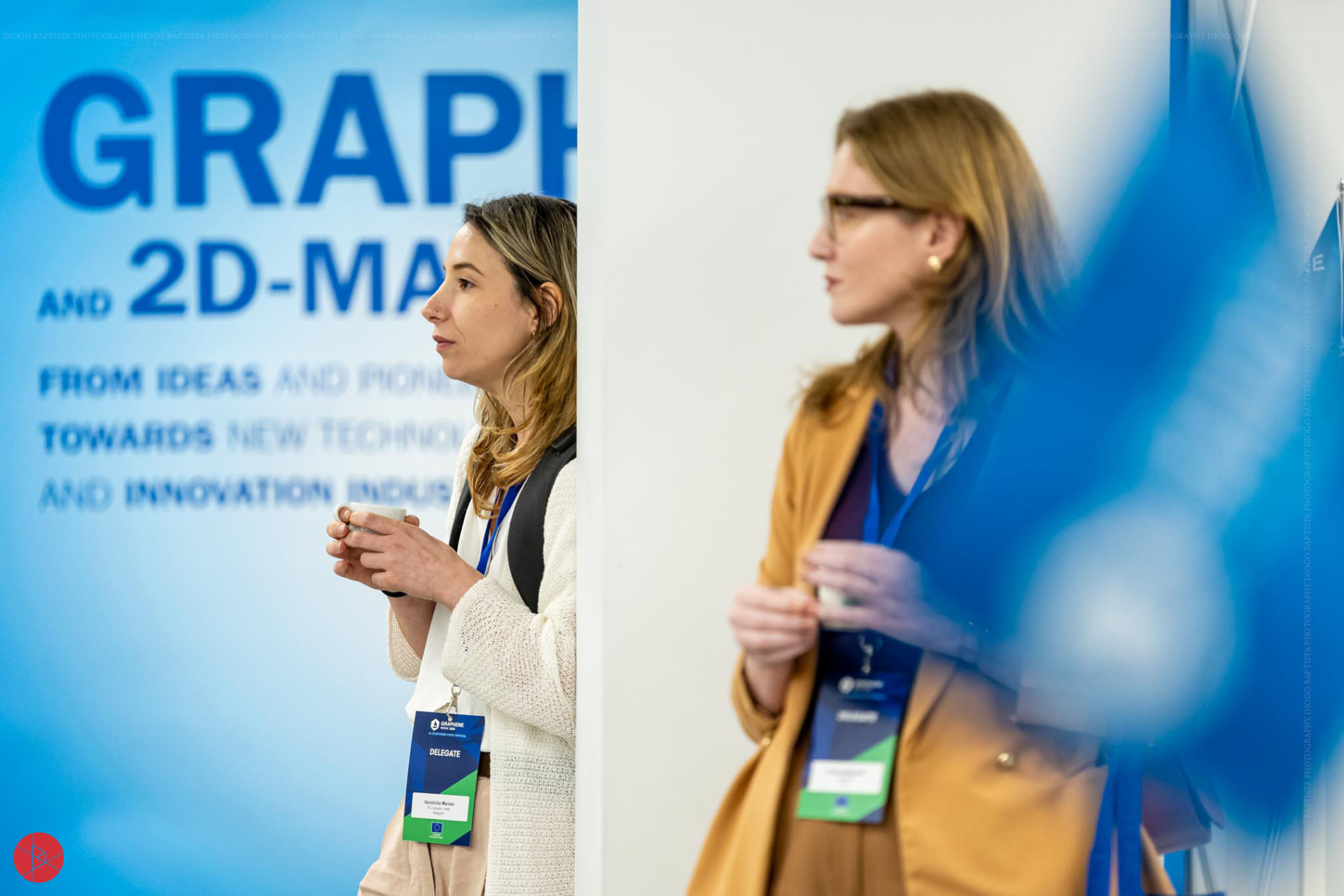 Two attendees meeting at the Graphene Week venue