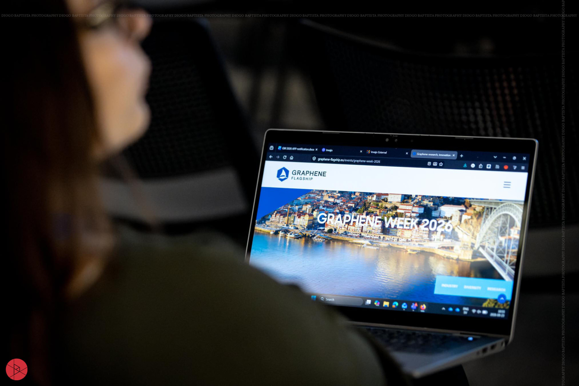 A conference attendee viewing the Graphene Week website on a laptop