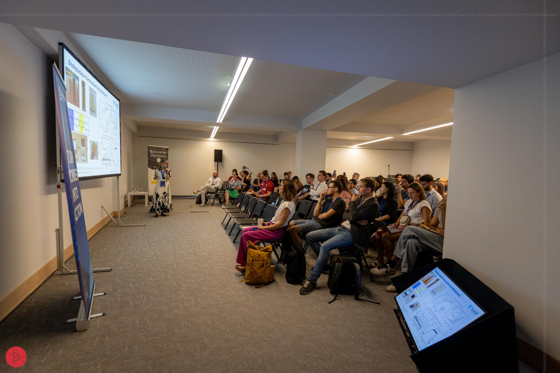 A scientific session with attendees listening to a presentation